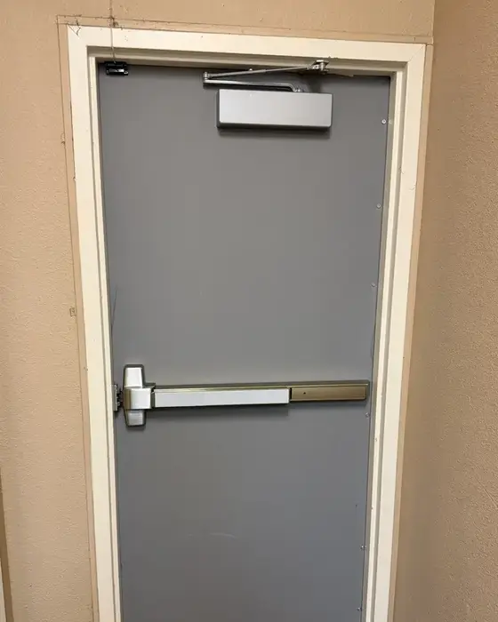 New steel exit door with panic bar and closer installed by Quick and Easy Locksmith at a TitleMax store in Dallas